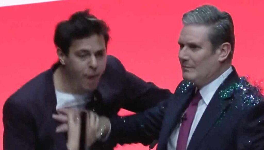 Keir Starmer speech – live: Protester covers Labour leader with glitter and screams into microphone
